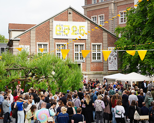 Viele Menschen besuchen die Er&ouml;ffnungsfeier der Jahresausstellung auf dem Hof der Kunsthochschule